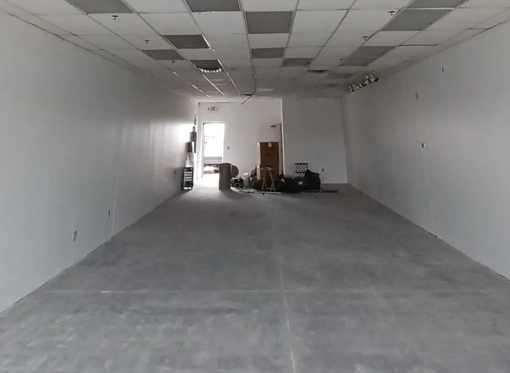 empty office space with some construction and moving equipment in the back