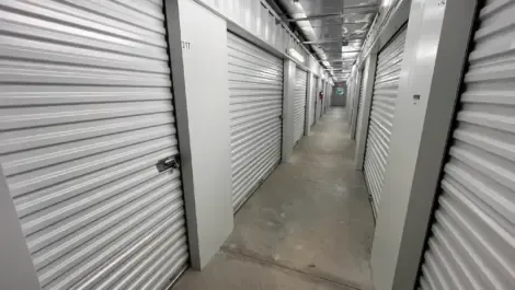 Row of indoor storage units with metal roll-up doors