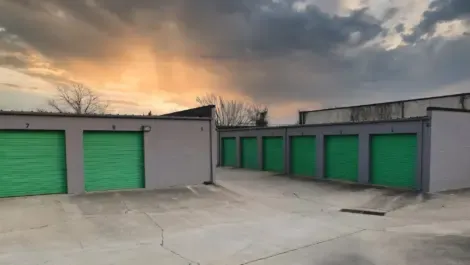 Group of outdoor storage units with closed metal roll-up doors