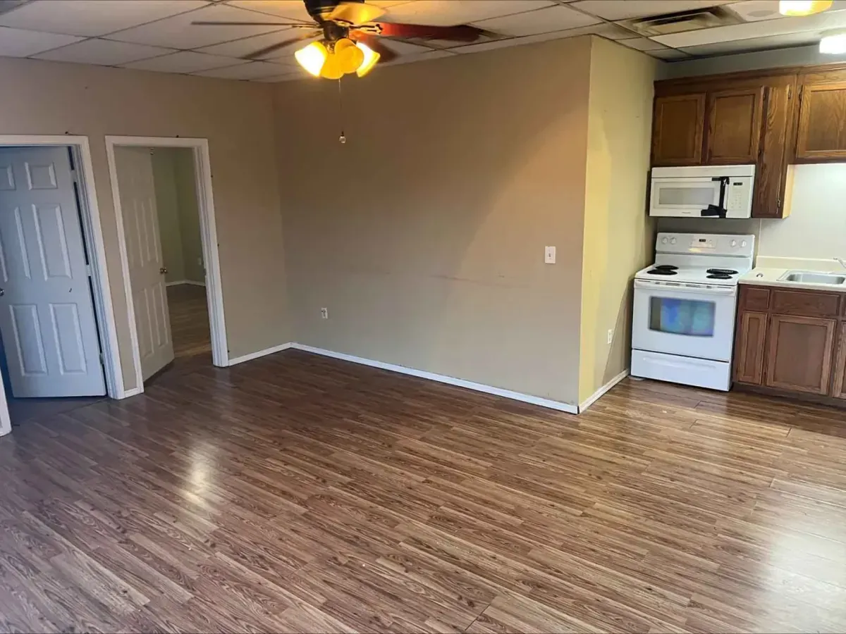 Interior of a room with wood floors a beige walls