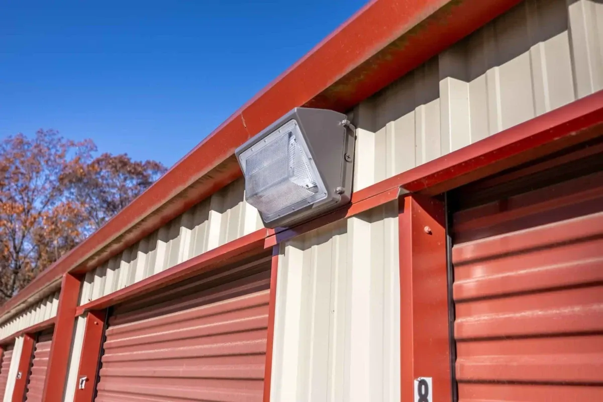 A floodlight between two storage units.