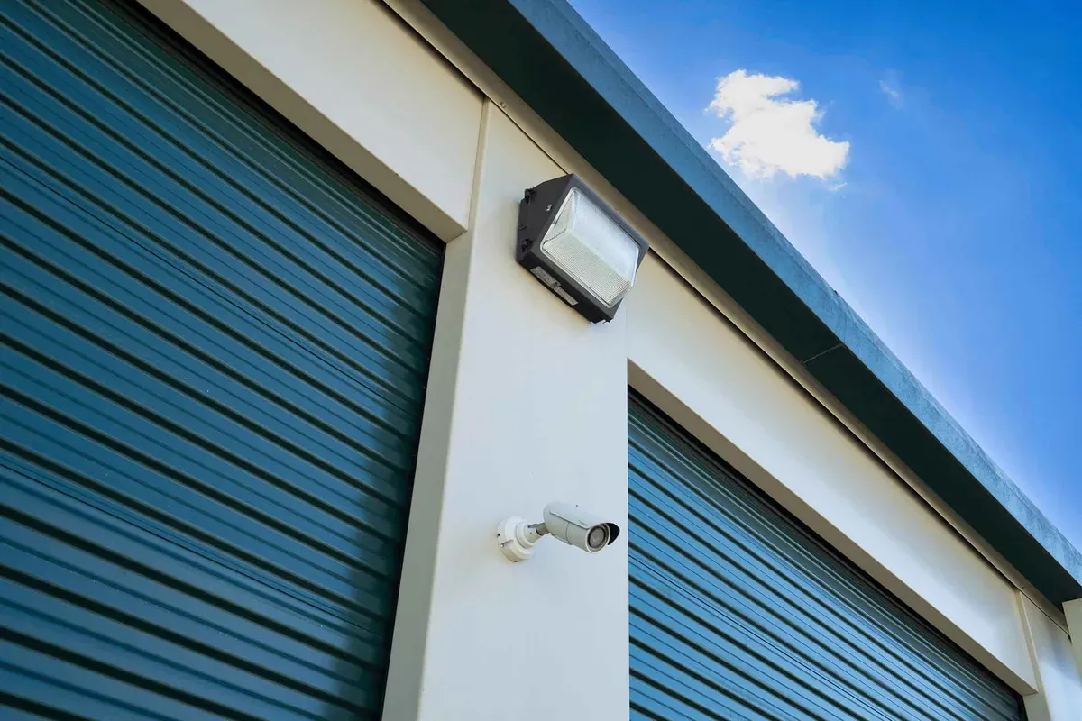 A light and camera near storage units.