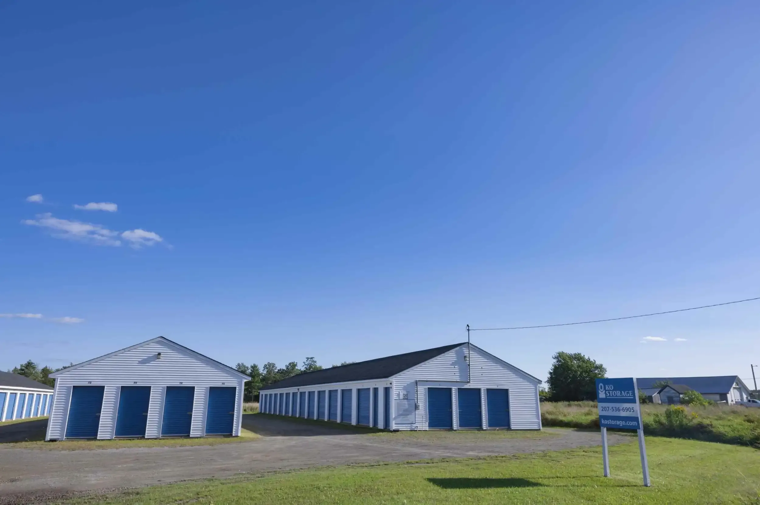 Storage unit buildings at the edge of the property.
