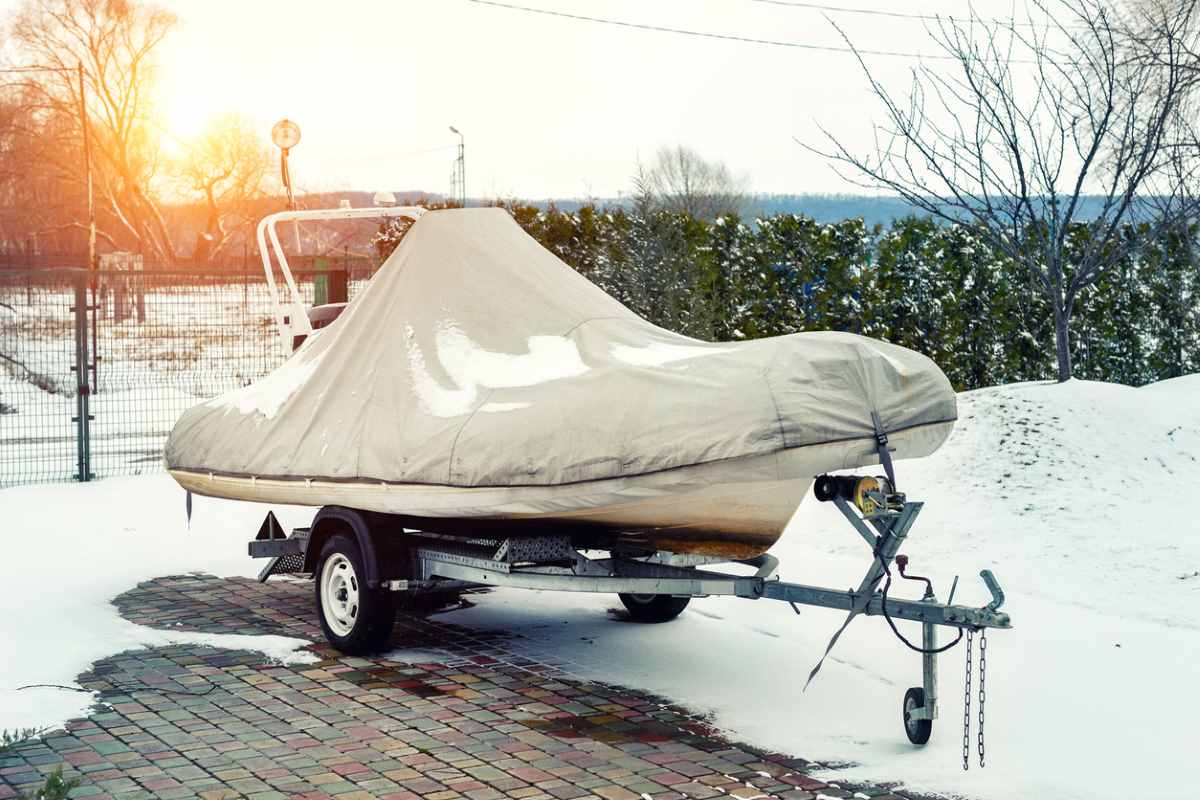 Boat covered by a tarp for falling snow protection outside