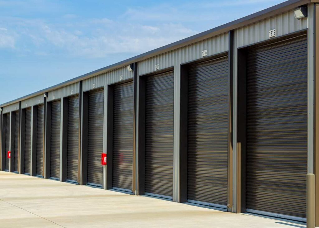 A series of outdoor, drive up storage unit doors. 