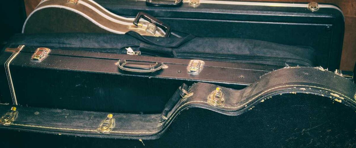 A collection of guitars in their cases ready to go into storage.