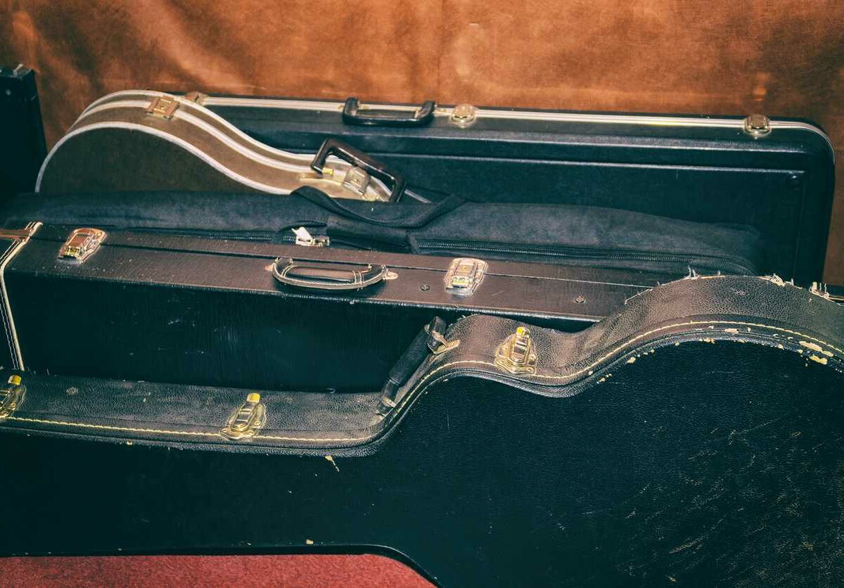 A collection of guitars in their cases ready to go into storage.