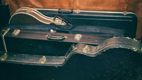A collection of guitars in their cases ready to go into storage.