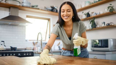 A woman cleans her kitchen counter as part of her spring cleaning initiative.