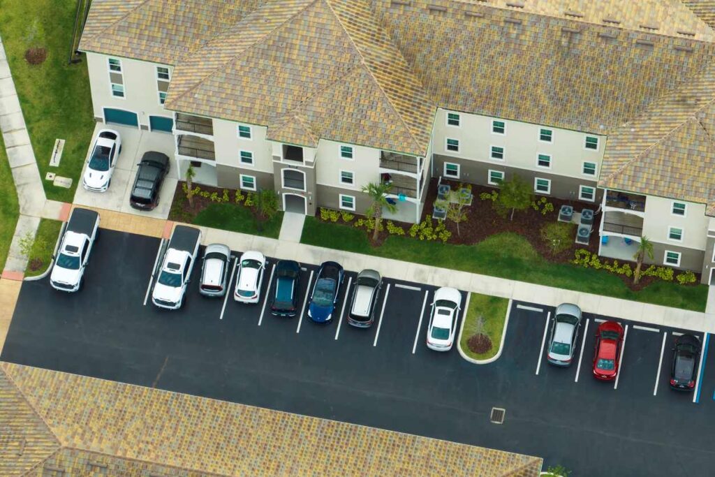 An aerial view of limited parking spaces outside an apartment building.