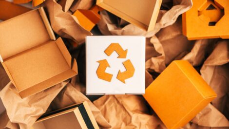 A collection of reusable cardboard boxes arranged in a recycling art piece.