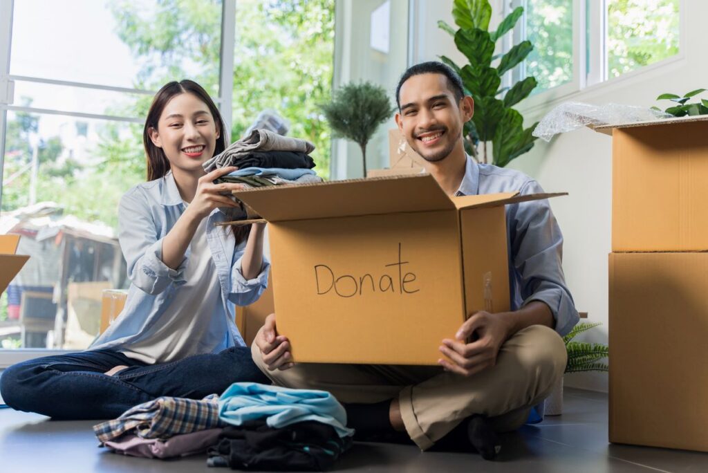 A man and woman pack things from their home to donate.