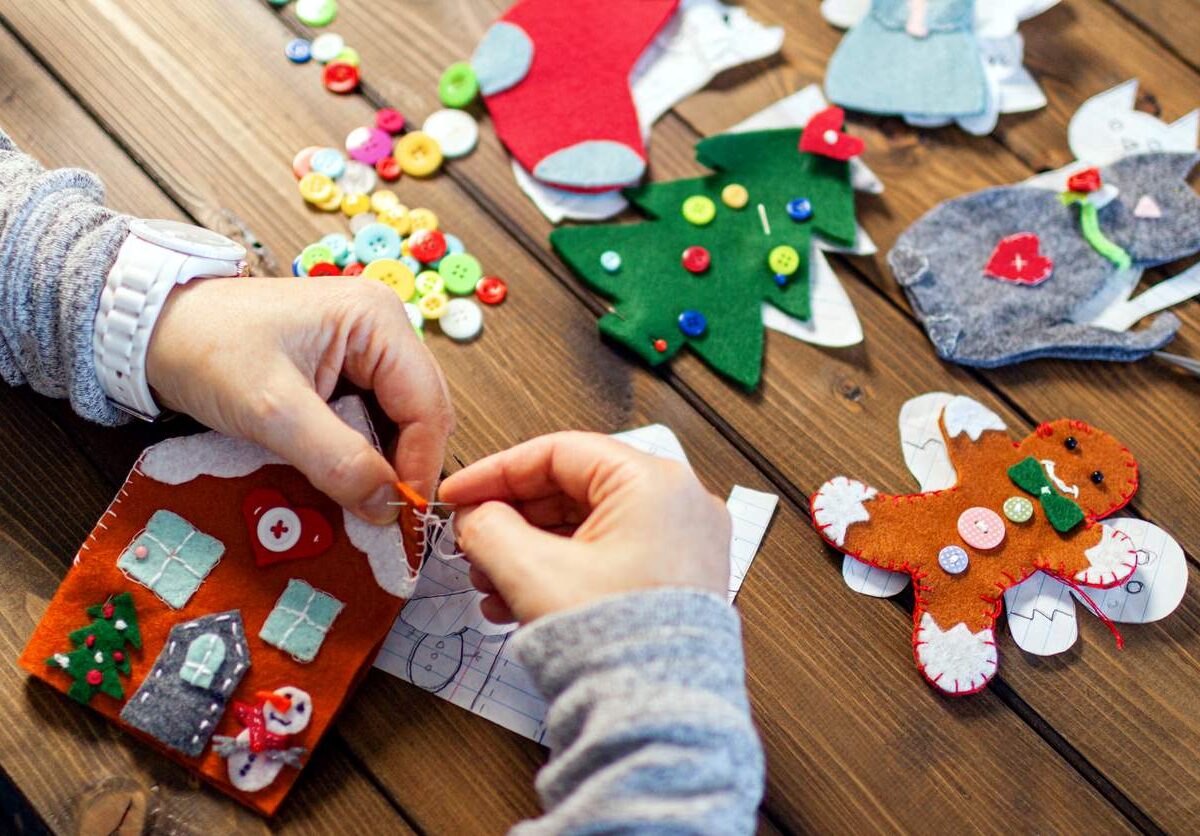 A woman makes DIY holiday decorations out of craft supplies.