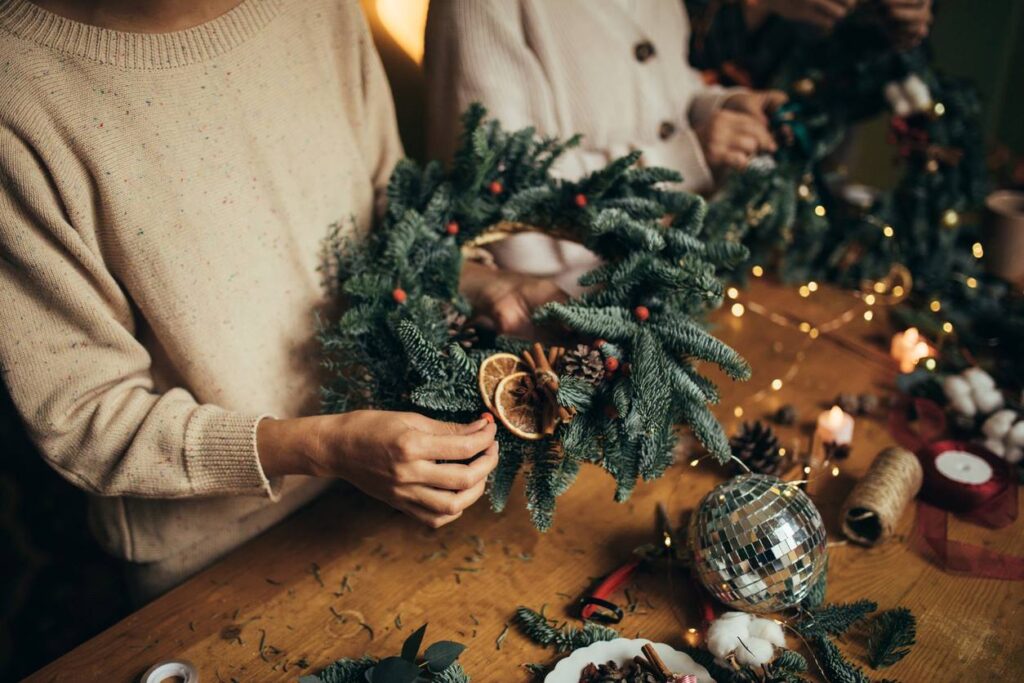 A woman makes DIY holiday decorations out of craft supplies.