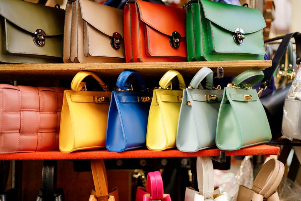 A line of colorful purses of different varieties