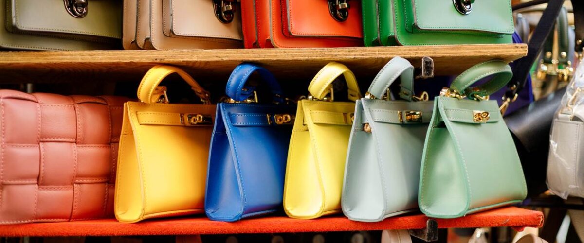 A line of colorful purses of different varieties