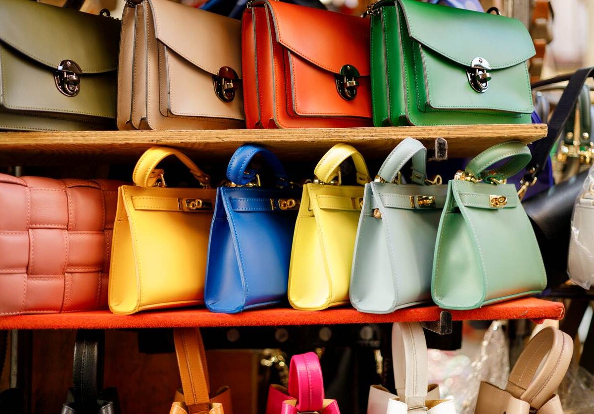 A line of colorful purses of different varieties