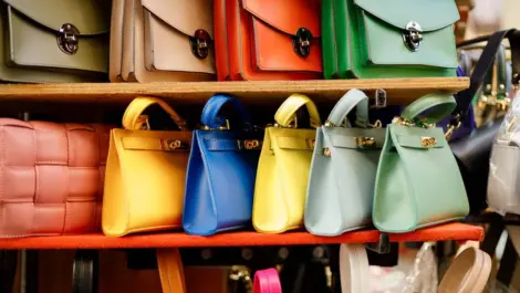 A line of colorful purses of different varieties