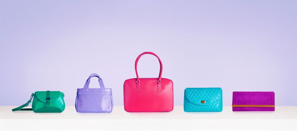 A line of colorful purses of different varieties