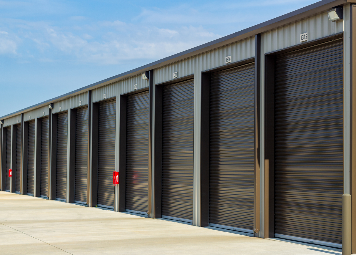 A row of closed, outdoor, drive-up storage units